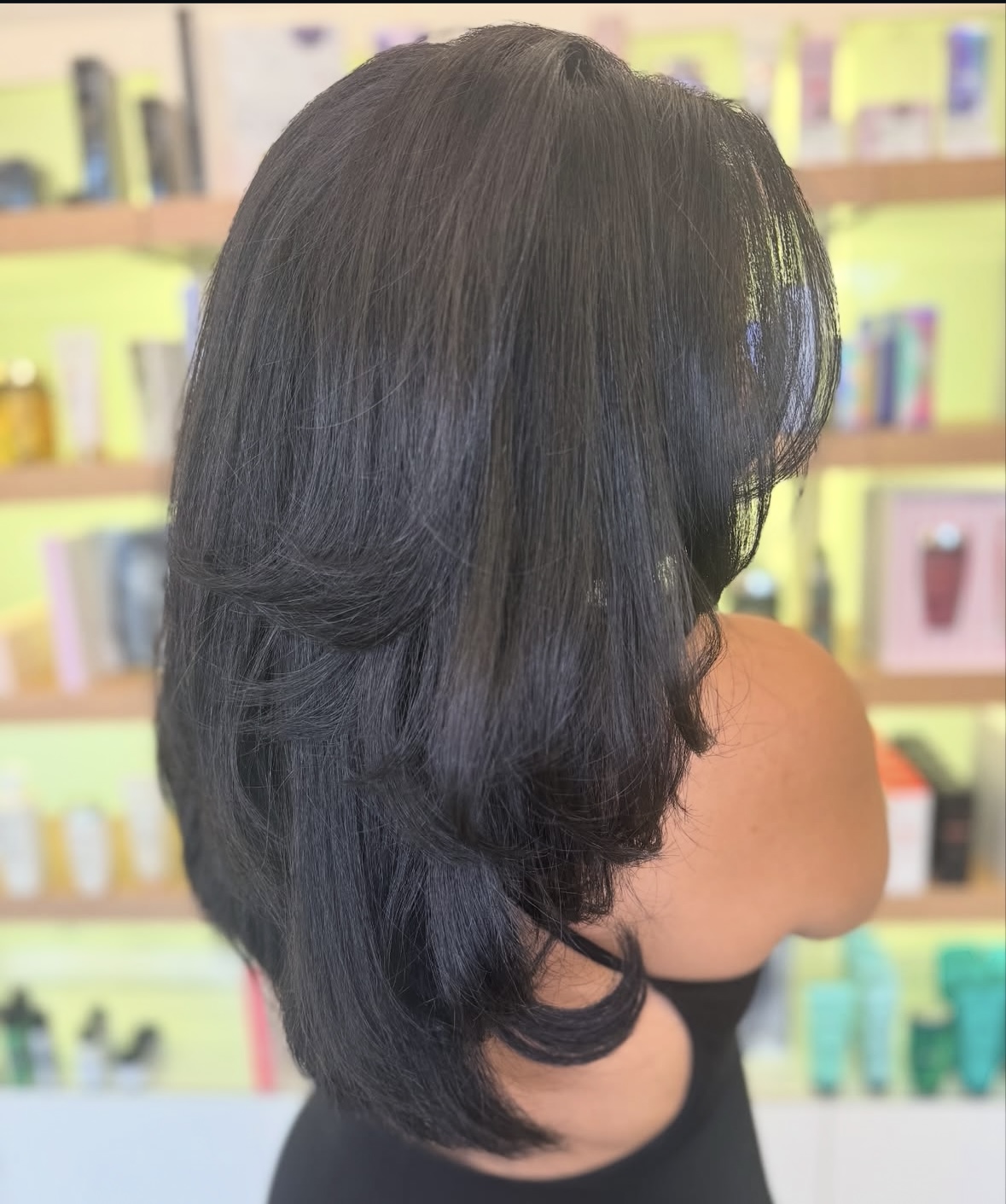 haircut-styling Brunette woman viewed from the rear after a haircut and styling service