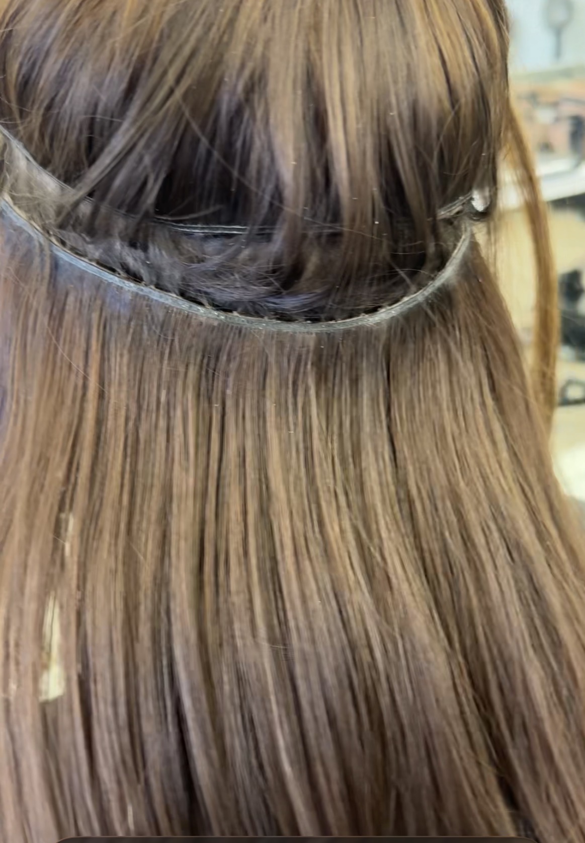 Before move-up Back of head view showing the before move-up position of hair extensions