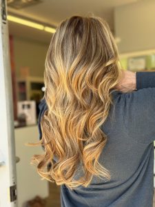 Woman viewed from behind with long blonde wavy hair